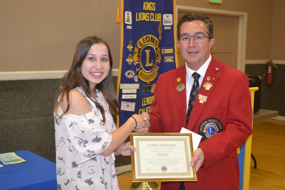Riverdale's Laila Roltin, 17, is congratulated for her speech by Kings Lions Club speech coordinator Jeff Garcia.